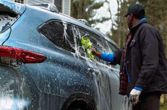 a guy washing a car